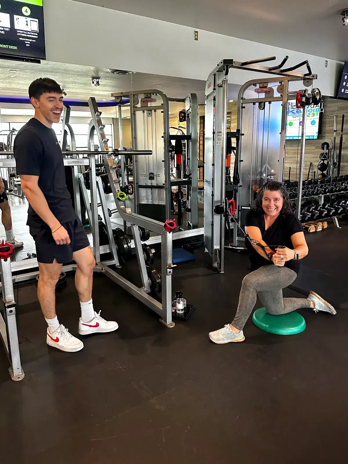 Client and coach sharing a high-energy moment during personal training at Prestige Fitness midtown Tucson